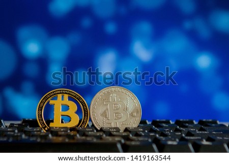 Bitcoin currency on keyboard computer on bokee background.Virtual cryptocurrency concept