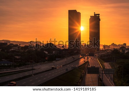 A city skyline of skyscrapers and landmark towers during a marvellous sunrise with beautiful sky colors