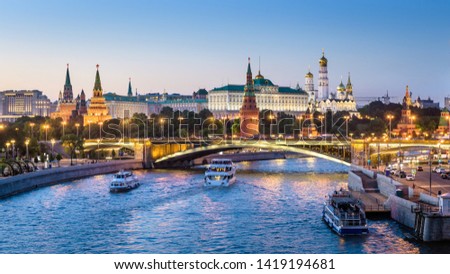 Moscow Kremlin at night, Russia. Beautiful view of Moscow city center in summer, panorama of Kremlin and Bolshoy Kamenny Bridge. Moscow cityscape with tourist boats on Moskva River. Travel theme. Royalty-Free Stock Photo #1419194681