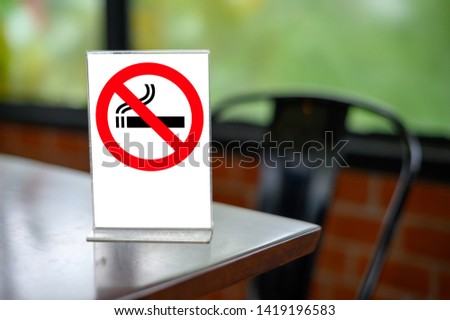 no smoking sign with shopping place background on wooden table