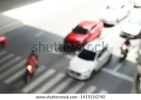 Blurred background of the traffic on the road which are many cars and motorcycles with copy space in transportation concept.