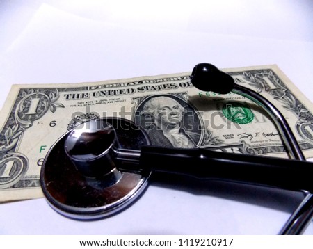 One dollar banknote and stethoscope on white background. Health and money