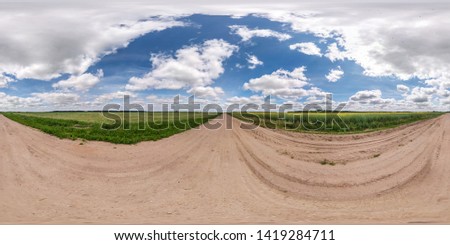 spherical hdri panorama 360 degrees angle view on gravel road among fields in summer day with awesome clouds in equirectangular projection, for VR AR virtual reality content