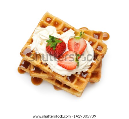 Yummy waffles with whipped cream, strawberries and caramel syrup on white background, top view Royalty-Free Stock Photo #1419305939