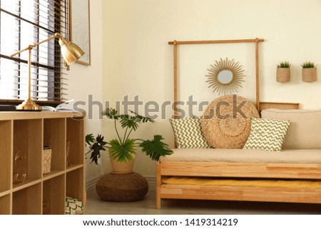 Living room interior with sofa, window blinds and stylish decor elements