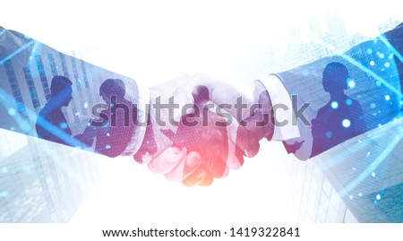 Handshake in city. Double exposure of planet hologram. International business partnership concept and hi tech. Toned image