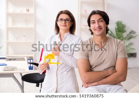 Female doctor checking patient's joint flexibility with goniometer