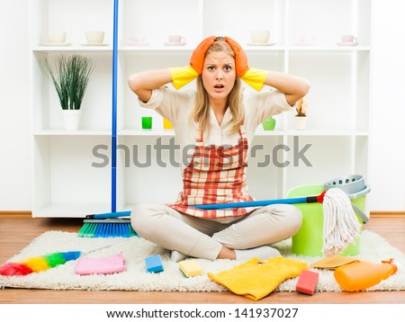 Young housewife is frustrated because of so many everyday chores,Exhausted housewife Royalty-Free Stock Photo #141937027