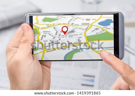 Smartphone with a generic city map with a pin