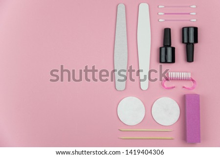 Flat lay geometry knolling set of manicure and pedicure tools on trendy pink background. Professional instruments for nail care. Beauty care concept theme.
