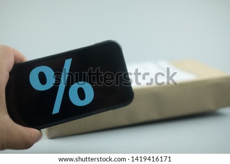 Smartphone with discount sign on screen in a shopping cart. Concept of online shopping