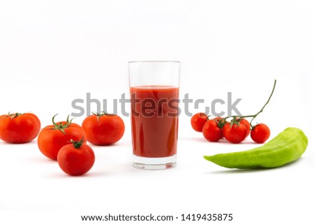 fresh tomato juice , pepper and tomatoes on a white background