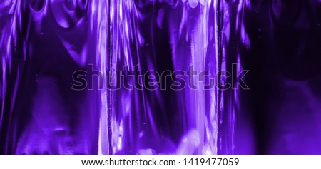 Photo of blur holographic foil texture. Trendy neon color.