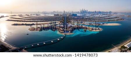 The Palm island panorama with Dubai marina rising in the background aerial view Royalty-Free Stock Photo #1419478073