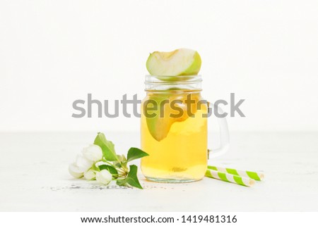 Apple juice, fresh fruit and blossom apple flowers on light background