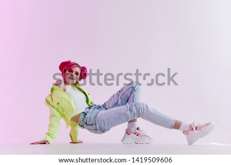 woman with pink hair is dancing on the floor