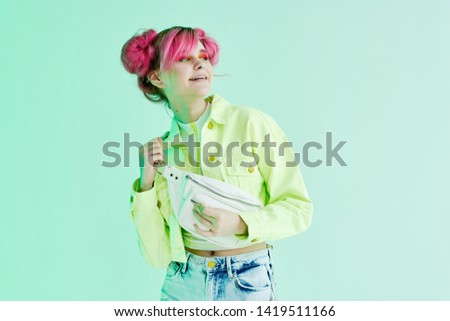 woman in a green jacket with pink hair
