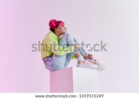 young woman with pink hair sitting