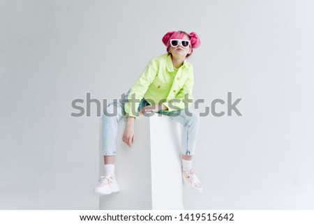 woman with pink hair in a green jacket