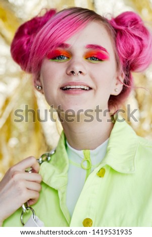 woman with bright pink hair make-up smiling portrait