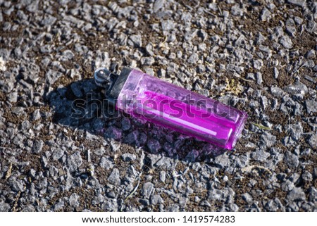 A photo of a lighter lying on the road