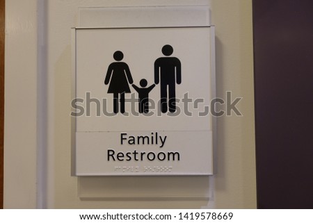 A sign signifying a family (men, women and children) bathroom or lavatory entrance.