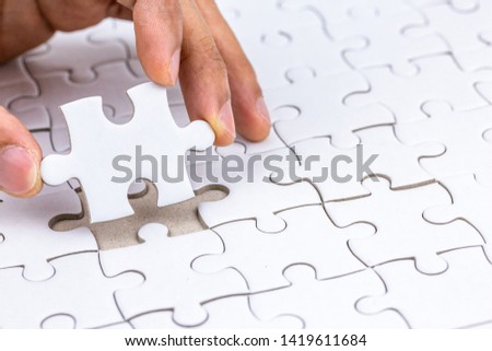 Hand holding piece of jigsaw puzzle and put to complete the missing part.Fulfill and  fix the problem of incomplete.Business solutions for success and strategy concept.
 Royalty-Free Stock Photo #1419611684