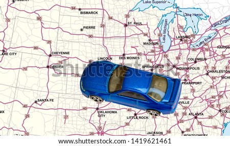 Close up view on blue car toy and United States of America road map. - image