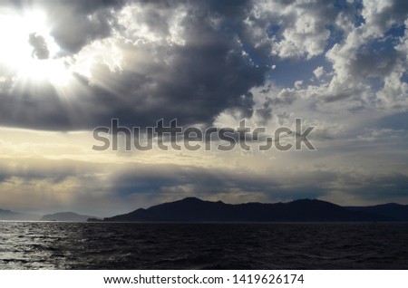 view of the setting sun in the clouds over the Aegean Sea