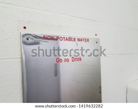 non-potable water do not drink sign on bathroom mirror