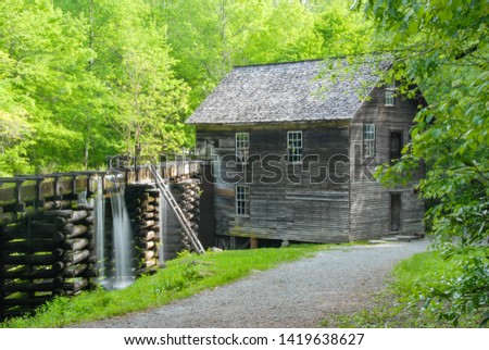 This is a color photo of a 1886 grist mill with demonstrations of its still-functional sluice, turbine & other machinery located in the Great Smoky Mountains National Park.