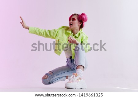 a woman with pink hair sat down eighties style