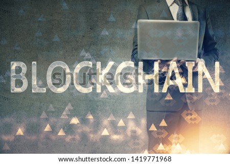 Crypto currency theme hologram with businessman working on computer on background. Concept of blockchain. Double exposure.