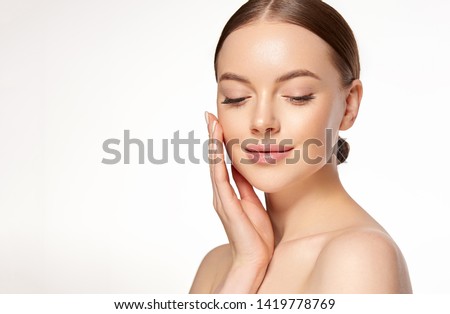 Beautiful young woman with clean fresh skin on face . Girl facial  treatment   . Cosmetology , beauty  and spa .
 Royalty-Free Stock Photo #1419778769