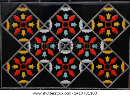 Black tiles with red yellow and blue arnament