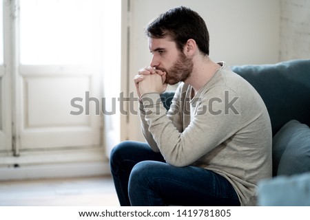 Unhappy depressed caucasian male sitting and lying in living room couch feeling desperate a lonely suffering from depression. In stressed from work, anxiety, heartbroken and men Health care concept. Royalty-Free Stock Photo #1419781805