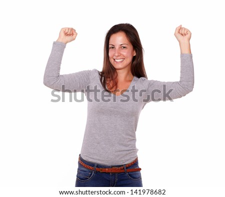 Portrait of a happy female celebrating a victory smiling at you on isolated background