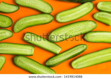 Slices of long cucumber slices on a white background .