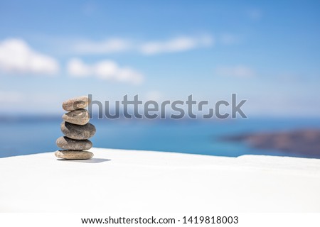 Zen stones on beautiful white wooden ground against blue sky. Dreamy scenery, inspirational nature concept. Nature balance and pattern with copy space 