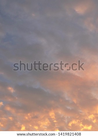 Background Pattern, Fiery Golden Sunrise Sky with Sunlight and Small White Clouds in The Morning with Copy Space for Text Decorated. 
