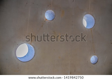 Background - almost abstract planet in space like view of inside of concrete tunnel with holes to the  bright outside