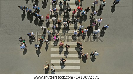 Aerial. People crowd on pedestrian crosswalk. Top view. 