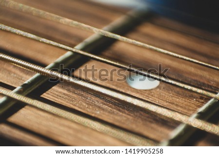 Macro close up shot of acoustic guitar strings on sun shine. Music and guitar playing concept Royalty-Free Stock Photo #1419905258