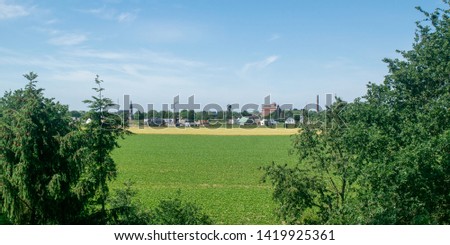 Skyline of German city goch with agriculture field in the foreground