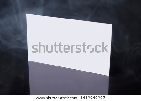 Business card blank on black background with smoke and reflection, flat lay, copy space for text
