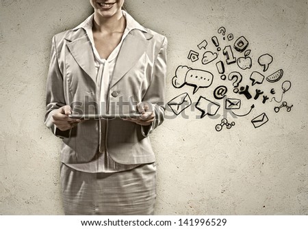Image of young woman holding in hands ipad