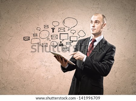Image of businessman holding ipad in hands