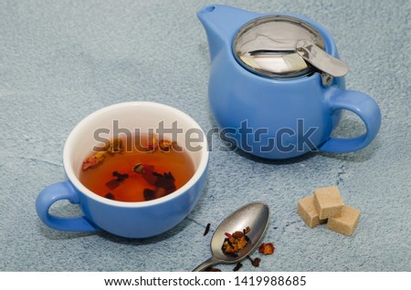 Hibiscus and rose tea in a cup and teapot 