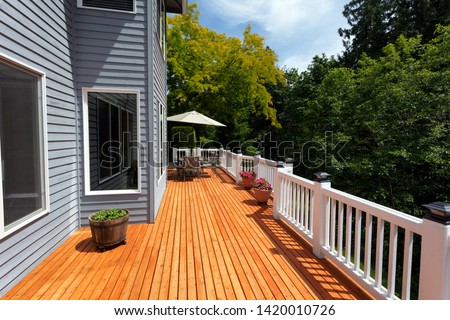 New red cedar outdoor wooden deck during nice weather in horizontal layout   Royalty-Free Stock Photo #1420010726