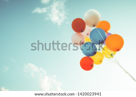 Colorful balloons done with a retro filter effect. Concept of happy birth day in summer and wedding, honeymoon party use for background. Vintage color tone style